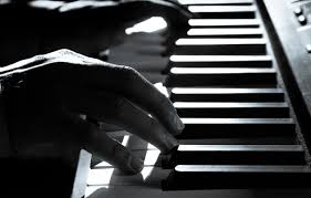 Hands on piano keys in black and white